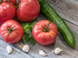 Organic food composition with tomatoes cucucmber,garlic and basil. Agriculture concept