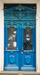 Old blue door with dusty cities