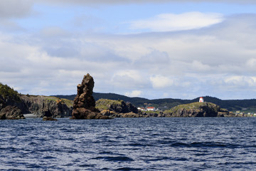 Sea stack and Light tower on coastline, Newfoundland and Labrador, Canada.