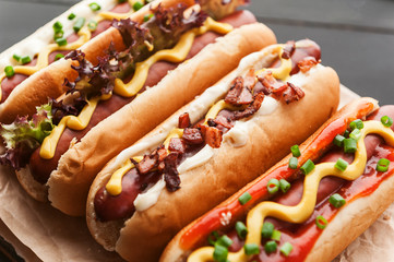Barbecue Grilled Hot Dogs with  yellow American mustard, On a dark wooden background