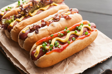 Barbecue Grilled Hot Dogs with  yellow American mustard, On a dark wooden background