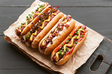 Barbecue Grilled Hot Dogs with  yellow American mustard, On a dark wooden background