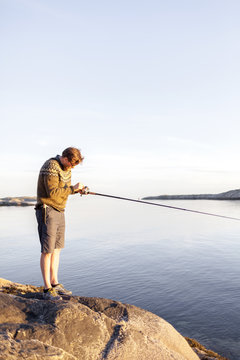 A man fishes for cod on the Lofoten island in Norway 