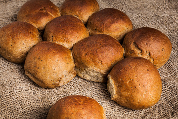 Freshly baked wheat-rye buns close-up. Delicious and healthy rustic bread