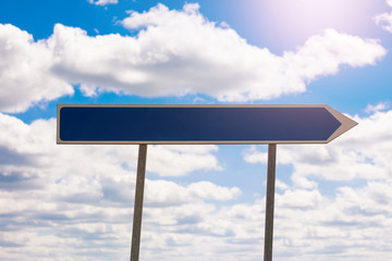 Blank blue road sign template for text with arrow to right direction on sky background. Copy space