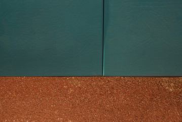 Green home run wall with track dirt.