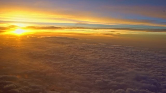 4K Aerial Traveling Wonderful view of the sky and clouds with the twilight from above, as seen through an airplane window-Dan