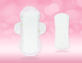 Sanitary napkin and pad (front side, close-up) in new, clean, thin and white features isolated on gradient pink background and bokeh (clipping path included) for menstrual period day on every month © artissp
