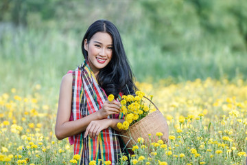 Naklejka na ściany i meble Beautiful asian gardener girl in marigold flowers field 