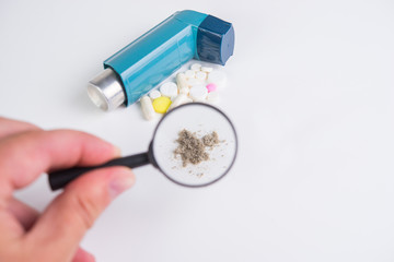 Inhaler for relief of attacks of allergy and asthma, tablets and various medications and household dust as an allergen close-up
