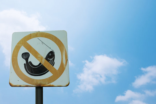 Sign warned do not fishing in this area isolated on blue sky background with clipping path included