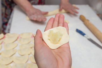 Cook cooks vareniki with potatoes