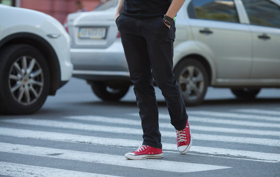 Walking on zebra crossing outdoors background. Unrecognizable obscured walking