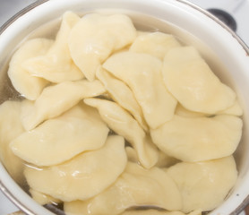 Vareniki with potatoes are cooked in a saucepan