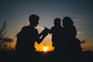 Silhouette, happy children with mother and father