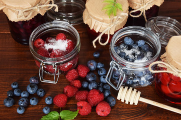 Obraz na płótnie Canvas blueberries and raspberries in jars for the winter tea