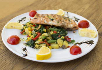 Delicious salad with chicken and vegetables. Caesar Salad with grilled chicken on a white plate.
