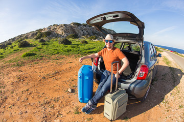 happy man enjoying road trip and summer vacation. Travel, holidays and people concept