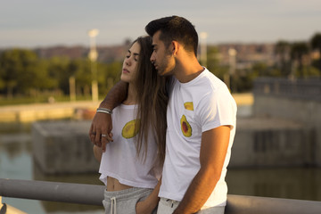 Teen couple holding at sunset