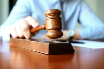 Judge holding gavel in courtroom