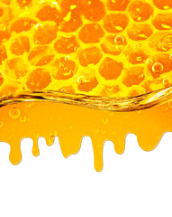 Honey flowing down from honeycombs and  wave