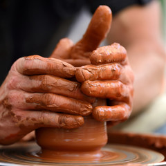 Obraz na płótnie Canvas Potter making ceramic pot on the pottery wheel