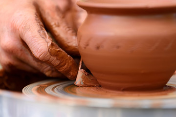 Potter making ceramic pot on the pottery wheel