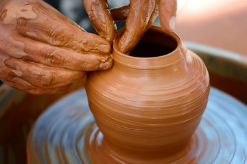 Potter making ceramic pot on the pottery wheel