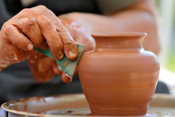 Potter making ceramic pot on the pottery wheel - obrazy, fototapety, plakaty