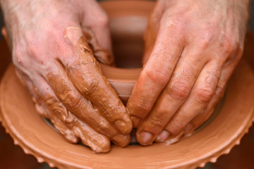 Potter making ceramic pot on the pottery wheel