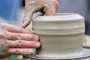 Potter making ceramic pot on the pottery wheel