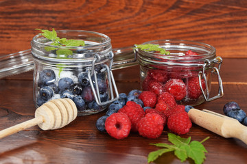 blueberries and raspberries in jars for the winter tea