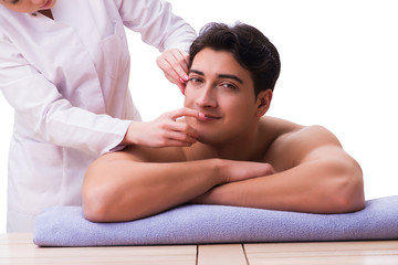 Handsome man in spa massage concept