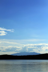 Blue sky over the mountain on the lake shore