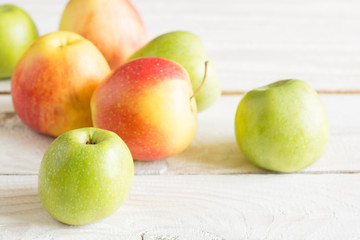Ripe apples on a wooden background