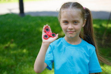 girl holding popular fidget spinner toy
