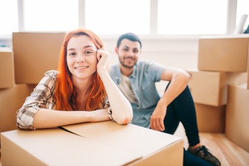 Couple sitting on the floor, moving to new house