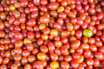 Pile of tomato (solanum lycopersicum) for sale at market ,Close-up red tomatoes background