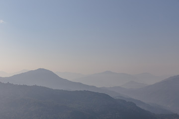Mountain and fog with orange to blur sky in the morning in winter in Gangtok. North Sikkim, India