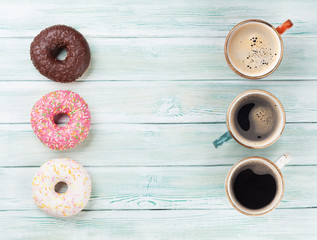 Coffee cup and colorful donuts
