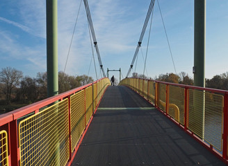 footbridge on steel rope over the river Elbe with standing man on the end