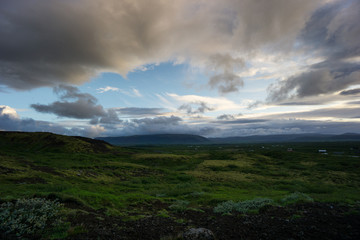 Iceland - Green volcanic landscape and awesome clouds at dawn
