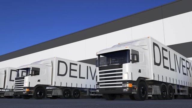 Speeding freight semi truck with DELIVERY caption on the trailer loading or unloading. Road cargo transportation. Seamless loop 4K clip