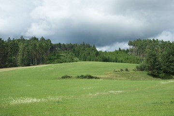 Green meadow and hills during sunny and cloudy afternoon. Slovakia