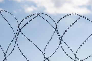 Safe protective metal fence with barbed wire