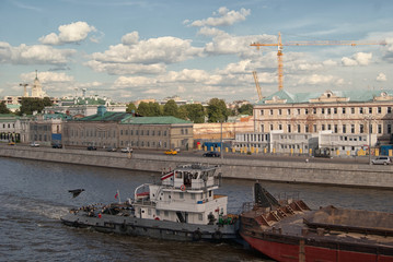 Water transport. River boat tow pusher in the canals of the Moscow river against the backdrop of...