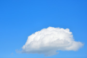 White and fluffy cloud on a clear blue sky