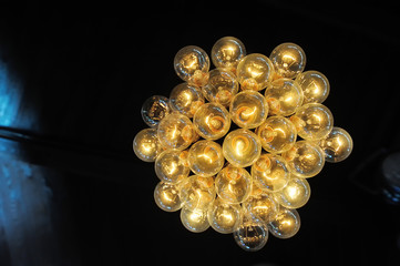 Creative chandelier on the ceiling of a set of retro light bulbs