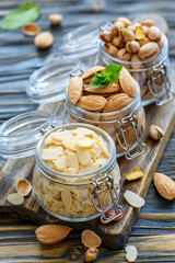 Almond flakes, almonds and pistachios in jars.