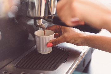 Waitress is making drink for client